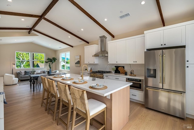 431 Seymour St, Napa, CA 94559 - kitchen with appliances with stainless steel finishes, wall chimney exhaust hood, light wood-style flooring, light countertops, and a sink