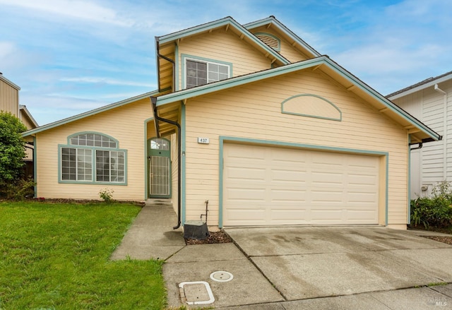 traditional-style home featuring an attached garage, driveway, and a front lawn