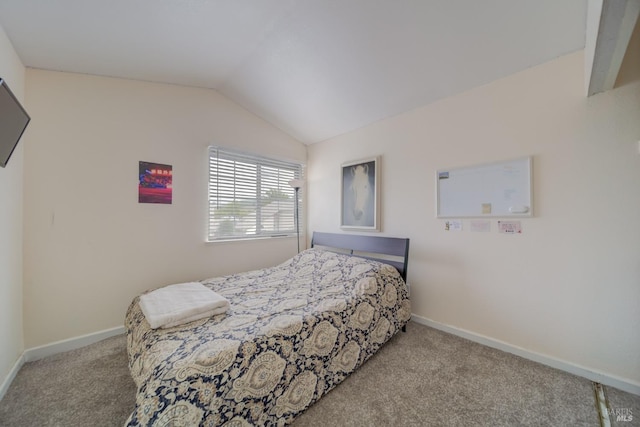bedroom with lofted ceiling, baseboards, and carpet floors