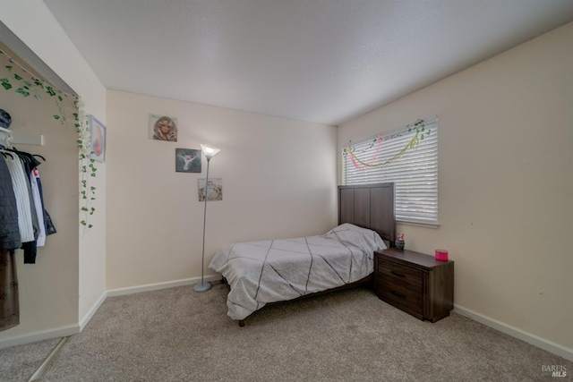 carpeted bedroom with baseboards