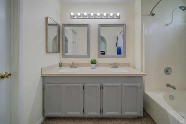 full bath with a sink, double vanity, and shower / bathing tub combination