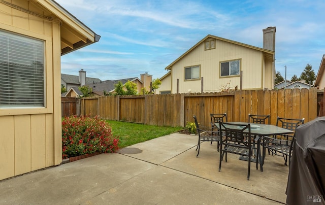 view of patio / terrace with outdoor dining area, a fenced backyard, and area for grilling