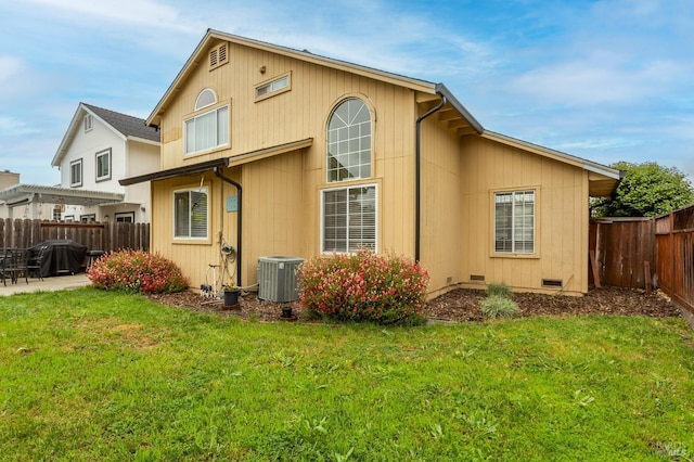 back of property with central AC, a yard, a patio, and a fenced backyard