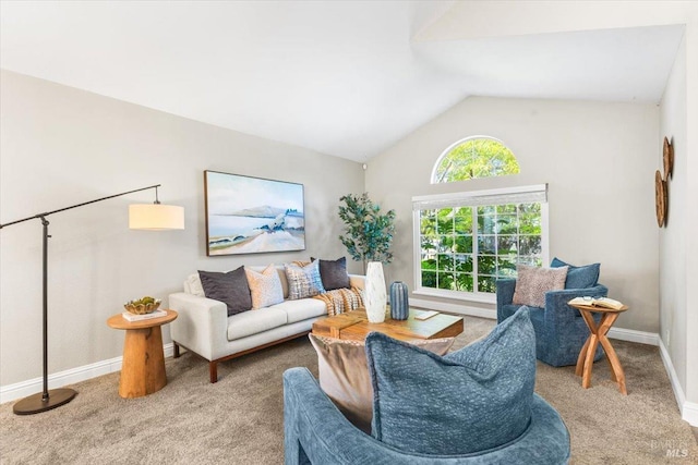 carpeted living area featuring vaulted ceiling and baseboards