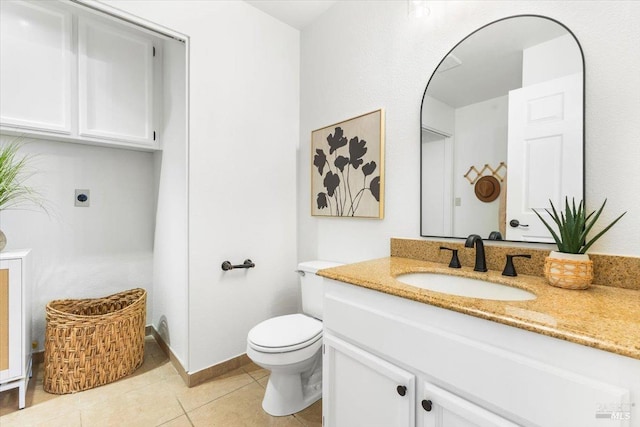 bathroom with tile patterned floors, vanity, and toilet