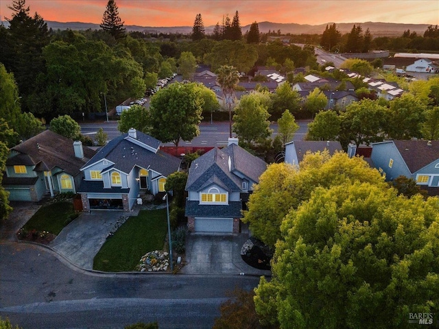 aerial view at dusk featuring a residential view