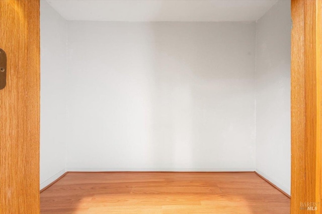 interior space featuring wood finished floors and baseboards