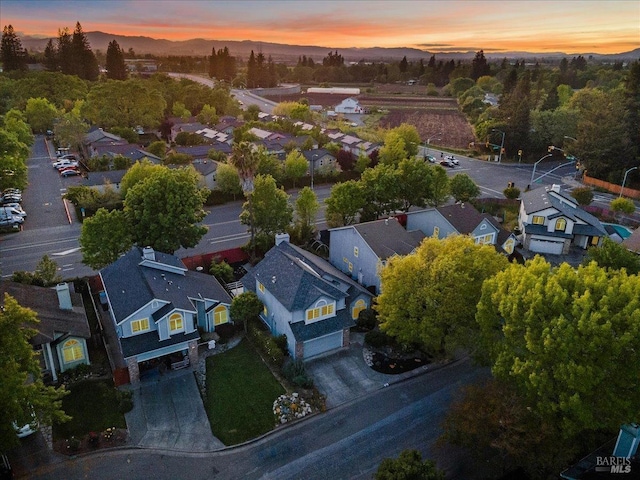 aerial view at dusk featuring a residential view