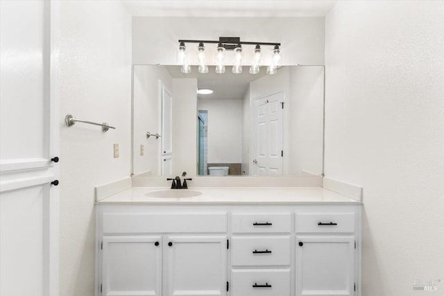 bathroom with vanity and a shower