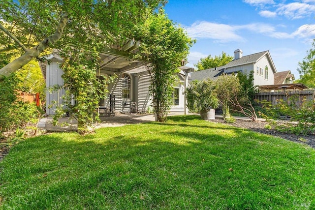 view of yard with fence, a pergola, and a patio area