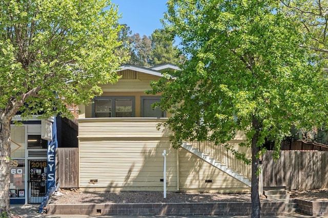 view of front of home featuring fence