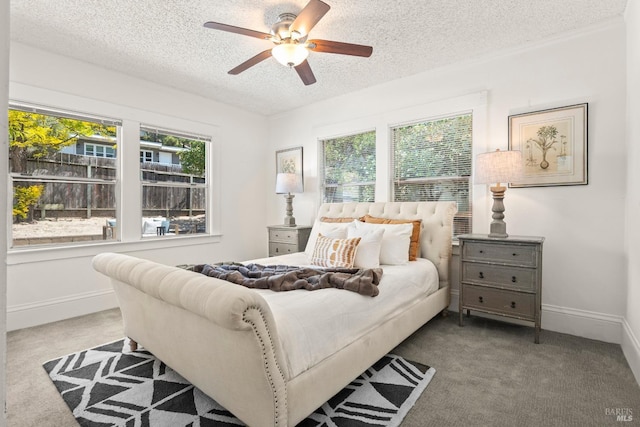 bedroom with carpet floors, baseboards, a textured ceiling, and ceiling fan