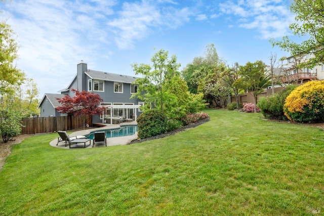view of yard with a fenced in pool, a patio, and fence
