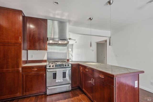 kitchen featuring stainless steel gas range, dark wood-style flooring, extractor fan, a peninsula, and pendant lighting