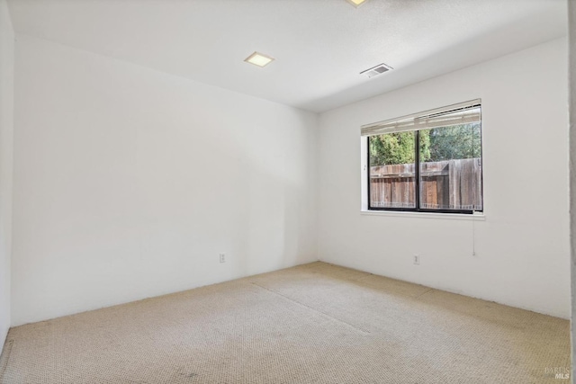 carpeted spare room with visible vents
