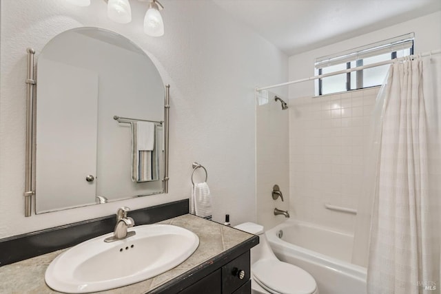 bathroom featuring toilet, shower / bath combo, and vanity