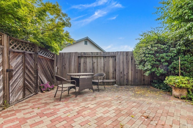 view of patio with a fenced backyard and outdoor dining space