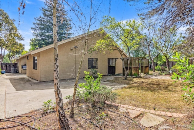 exterior space featuring fence, a patio, and stucco siding