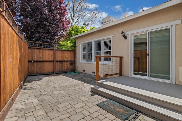 view of patio featuring fence and a deck