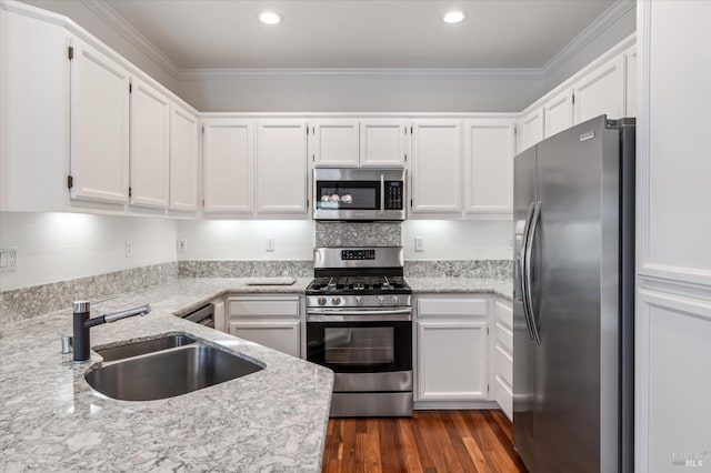 kitchen with dark wood-type flooring, white cabinetry, stainless steel appliances, and a sink