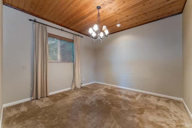 spare room with wooden ceiling, baseboards, carpet, and a notable chandelier