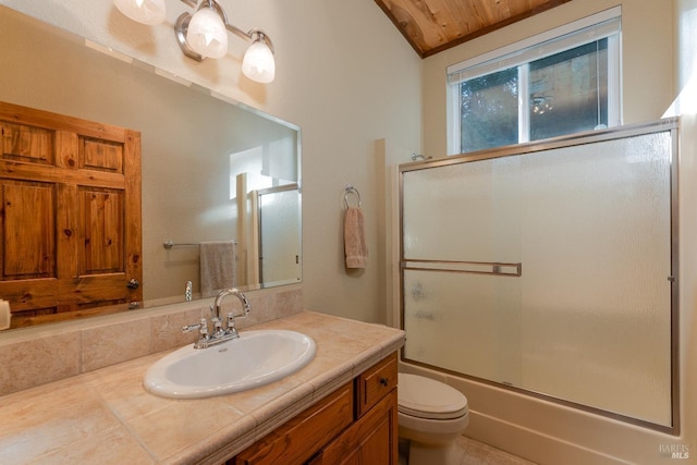 bathroom featuring vaulted ceiling, toilet, vanity, and enclosed tub / shower combo
