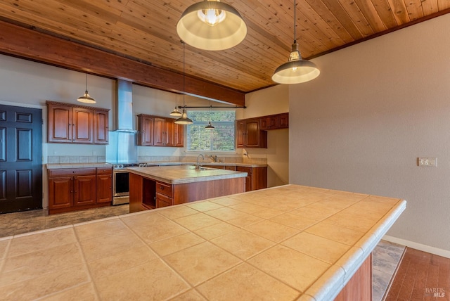kitchen featuring wall chimney range hood, wood ceiling, a center island with sink, light countertops, and electric range