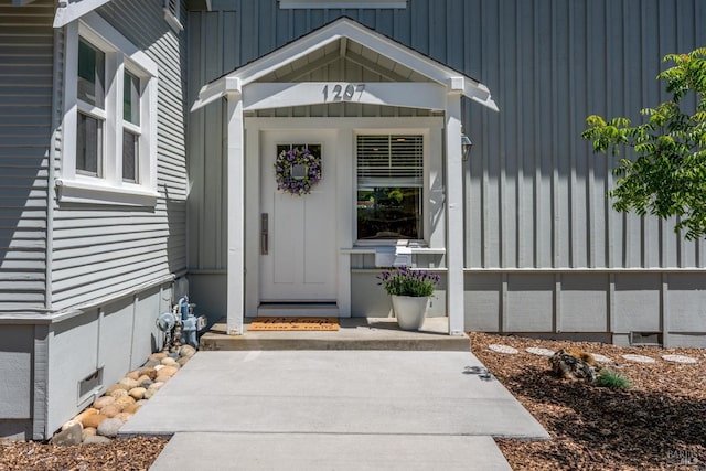 entrance to property with board and batten siding and crawl space