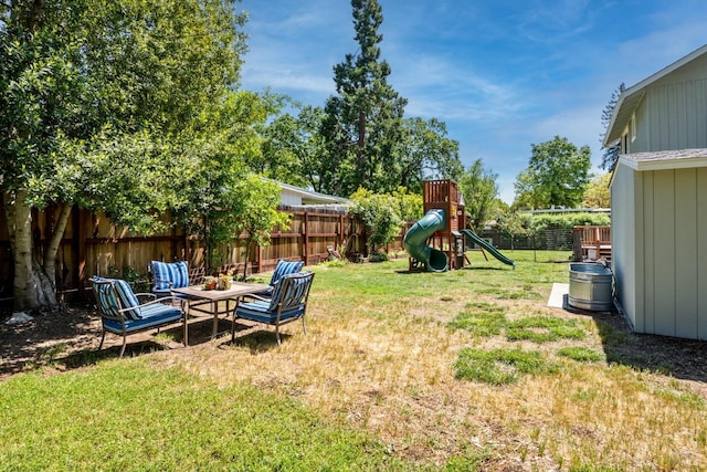 view of yard featuring a fenced backyard and a playground
