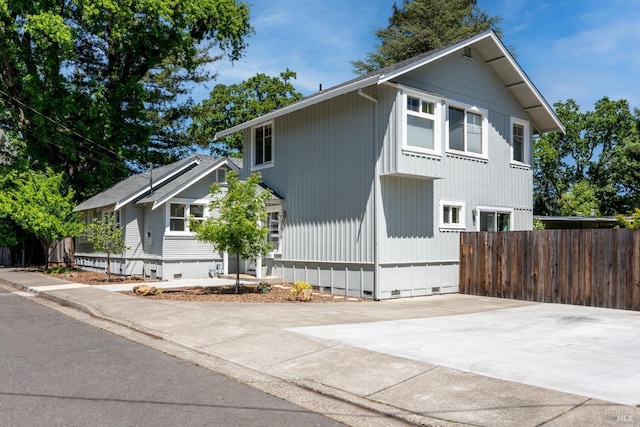 view of property exterior with fence and crawl space