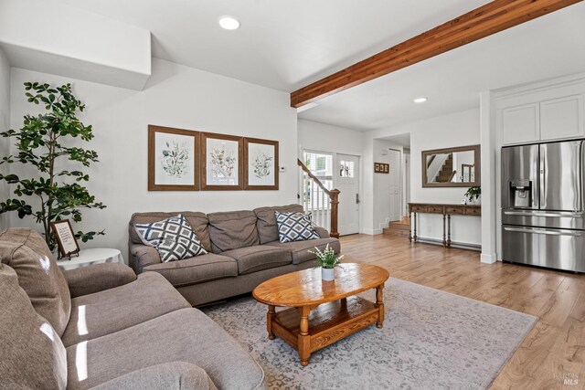 living area featuring recessed lighting, beamed ceiling, and light wood-type flooring