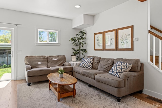 living room with stairs, recessed lighting, baseboards, wood finished floors, and visible vents