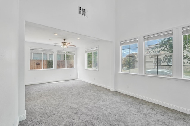unfurnished room featuring visible vents, baseboards, a ceiling fan, and carpet floors