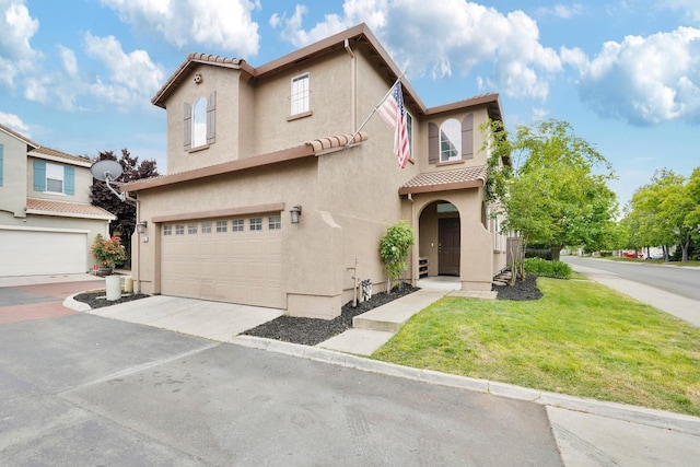 view of front of property featuring a garage, stucco siding, driveway, and a tiled roof