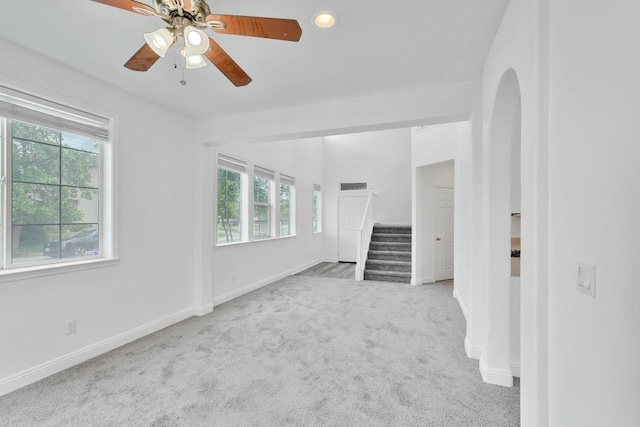unfurnished living room with recessed lighting, stairs, carpet, ceiling fan, and baseboards