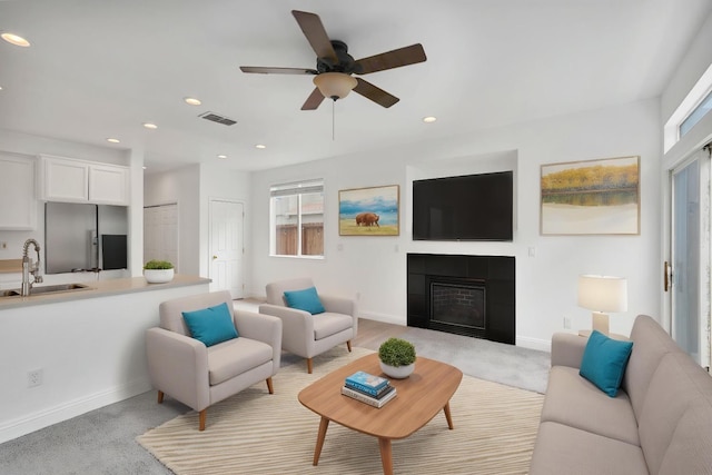 living area with baseboards, visible vents, ceiling fan, and recessed lighting