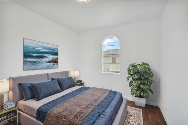 bedroom with wood finished floors and baseboards