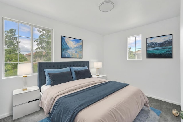 carpeted bedroom featuring baseboards