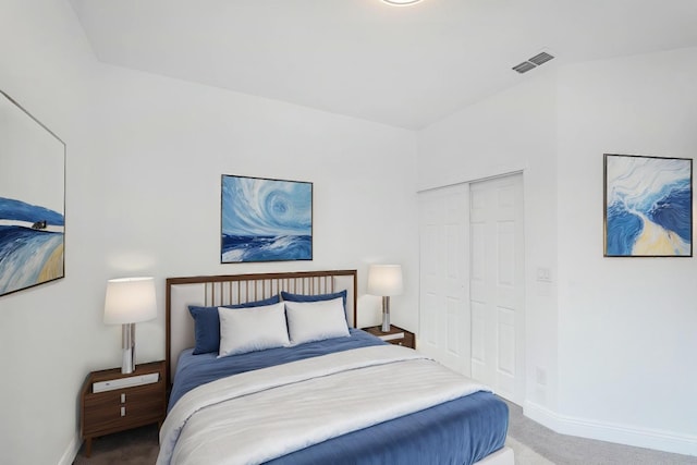 carpeted bedroom with a closet, visible vents, and baseboards