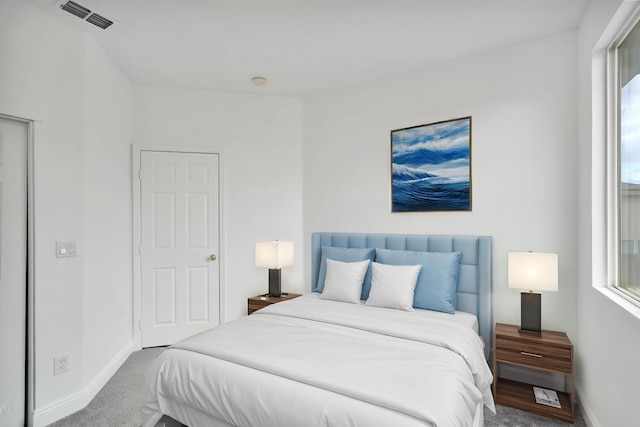 bedroom featuring visible vents, carpet flooring, and baseboards