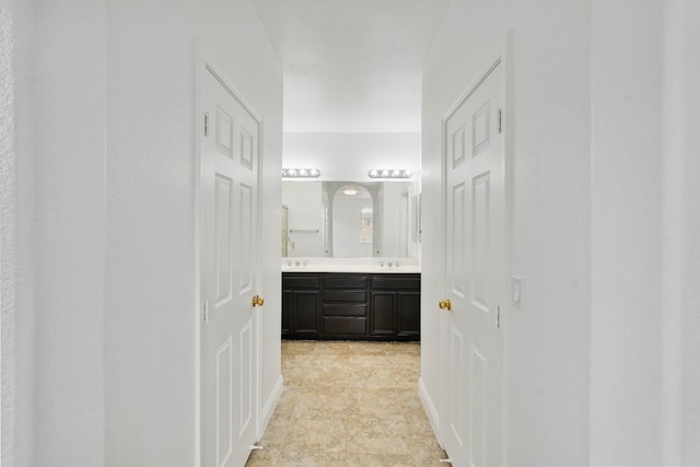 bathroom featuring a sink and double vanity