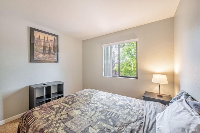carpeted bedroom featuring baseboards