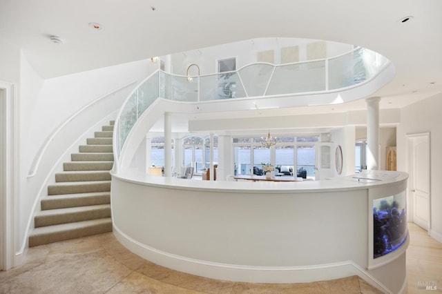 interior space with stairs, light tile patterned flooring, and a chandelier