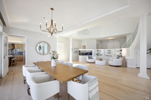 dining room featuring an inviting chandelier and light wood-type flooring