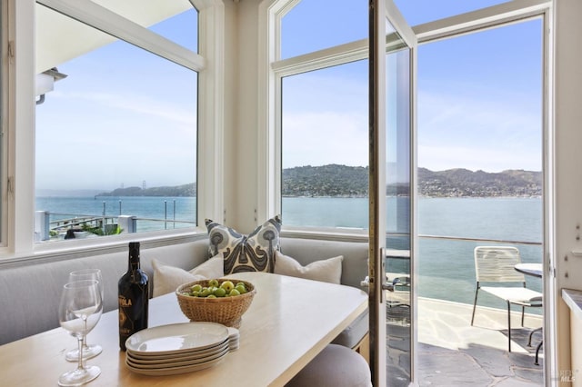dining area with a healthy amount of sunlight and a water view