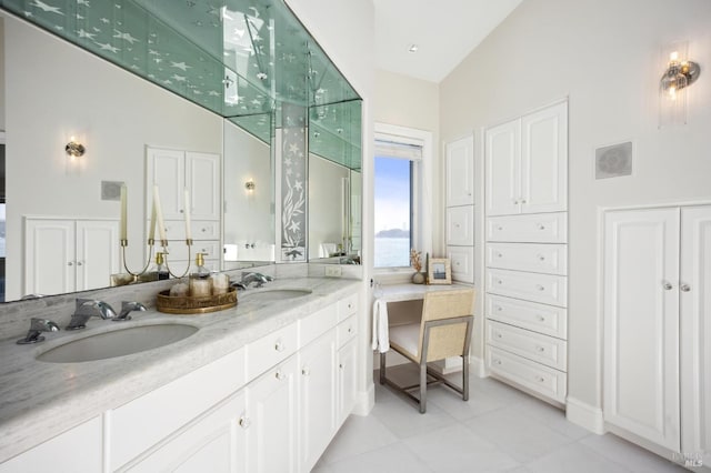 bathroom featuring lofted ceiling, double vanity, tile patterned flooring, and a sink