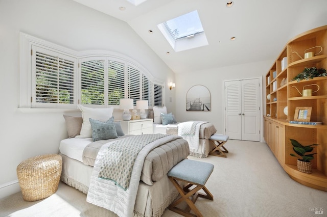 bedroom featuring light colored carpet, high vaulted ceiling, a closet, and a skylight