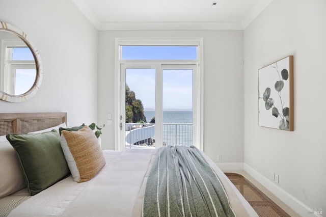 carpeted bedroom with baseboards, access to outside, a water view, and ornamental molding