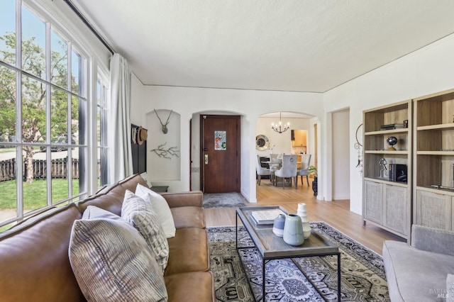 17 Hanns Ave, Vallejo, CA 94590 - living room with plenty of natural light, wood finished floors, arched walkways, and an inviting chandelier