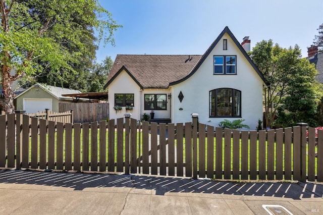 17 Hanns Ave, Vallejo, CA 94590 - english style home with stucco siding, roof with shingles, a garage, and a fenced front yard